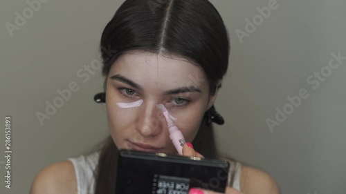 Young Caucasian Woman Concealing Acne. Make Up Procedure