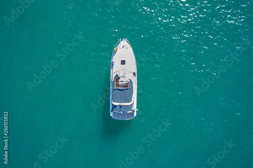 white yacht on blue water top view