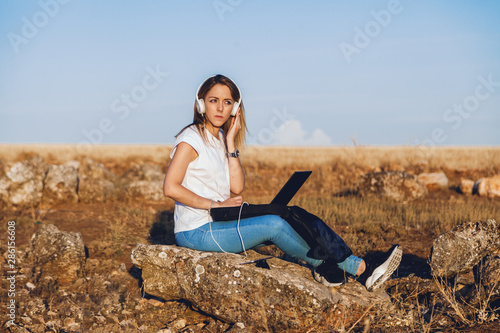Young woman with her laptop listened external communications
