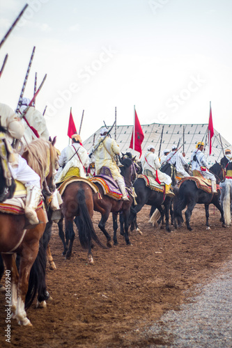 Tbourida  Fantasia Morocco Traditional Festival of horses ( Knights on horses with arms show ) photo