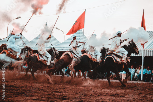 Tbourida Fantasia Morocco inezgane festival kssima knights on horses show with arms photo