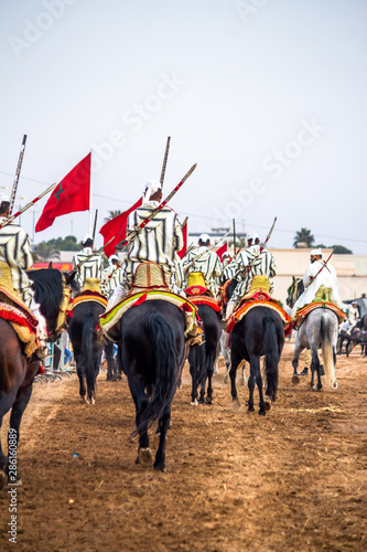Tbourida  Fantasia Morocco Traditional Festival of horses ( Knights on horses with arms show ) photo