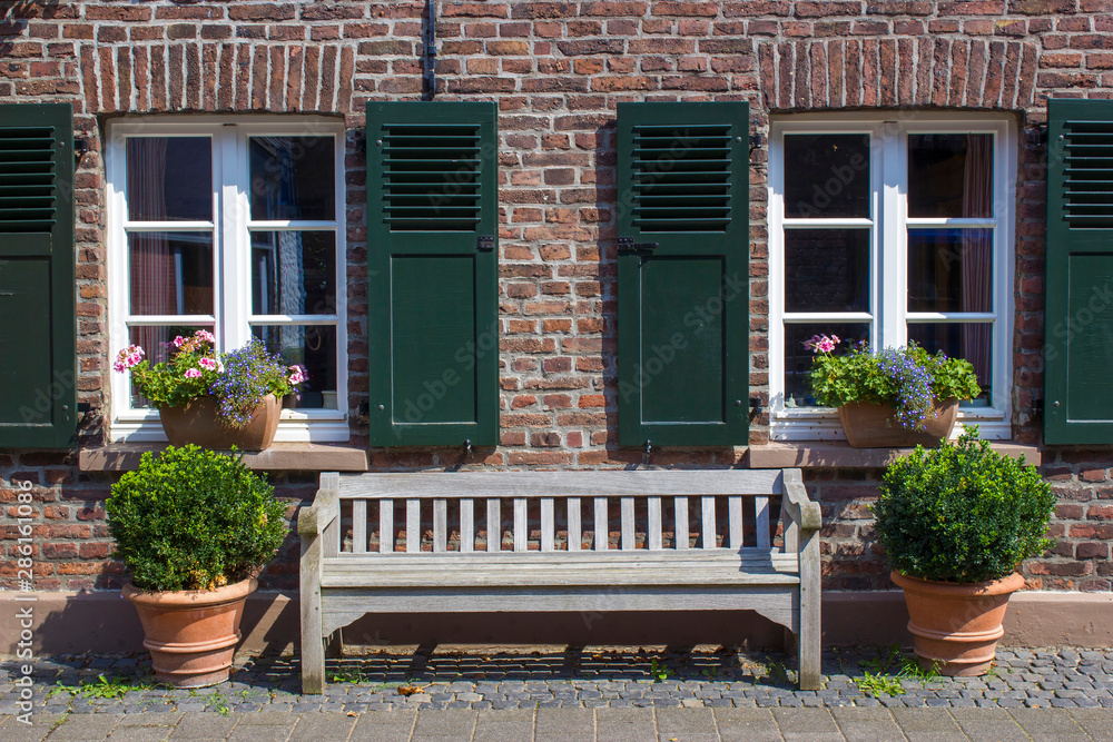 Old German house with windows with wooden shutters