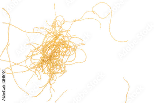 Lot of pieces of thin raw pasta noodles flatlay isolated on white background