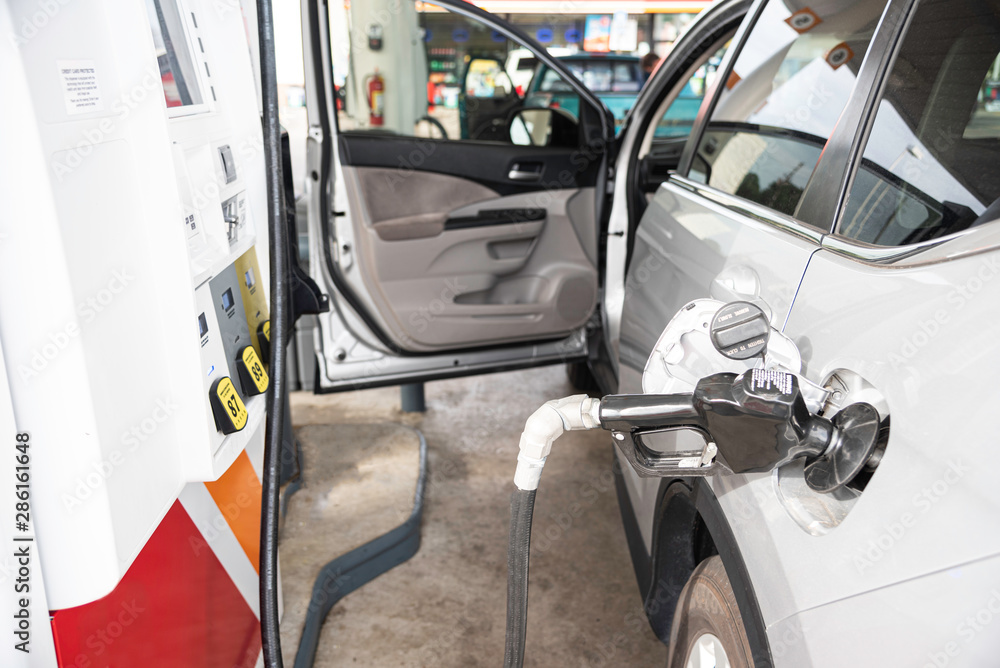 Filling A Vehicle’s Fuel Tank At A Gas Station Filling A Vehicle’s Fuel Tank At A Gas Station