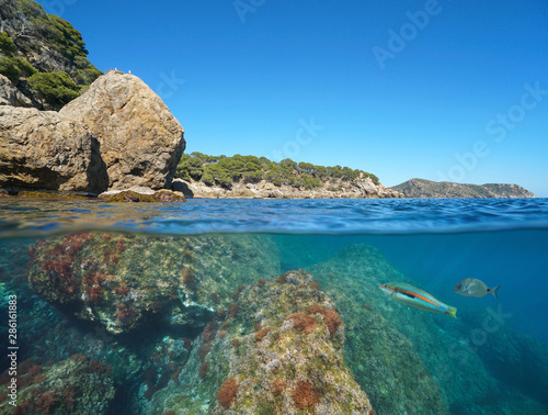 Wild rocky coast in Spain on the Costa Brava, Mediterranean sea, split view over and under water surface, Roses, Cap de Creus, Catalonia