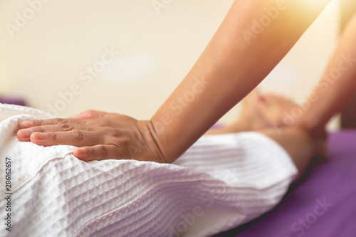 Woman having sports foot massage in Spa Salon. Leg massage treatment in the spa salon, A woman receiving a holistic massage treatment. Massaging tired muscles.