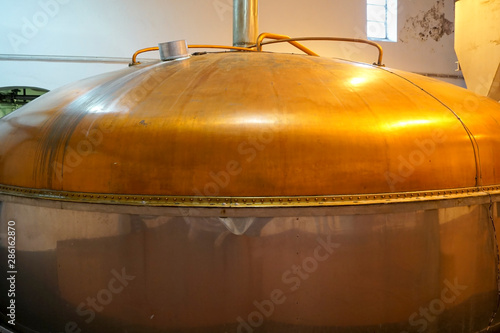 a large copper mash tun in a whisky distillery photo