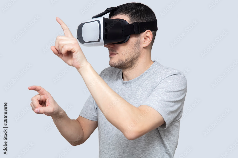 Young man using vr headset, experiencing virtual reality Young man using vr headset, experiencing virtual reality
