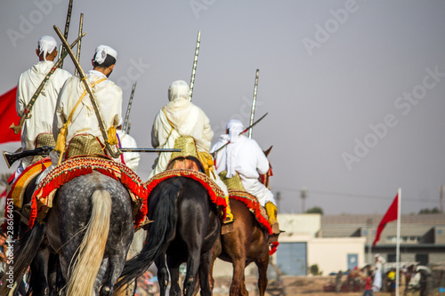 Tbourida Fantasia Morocco Traditional Festival of horses ( Knights on horses with arms show ) photo