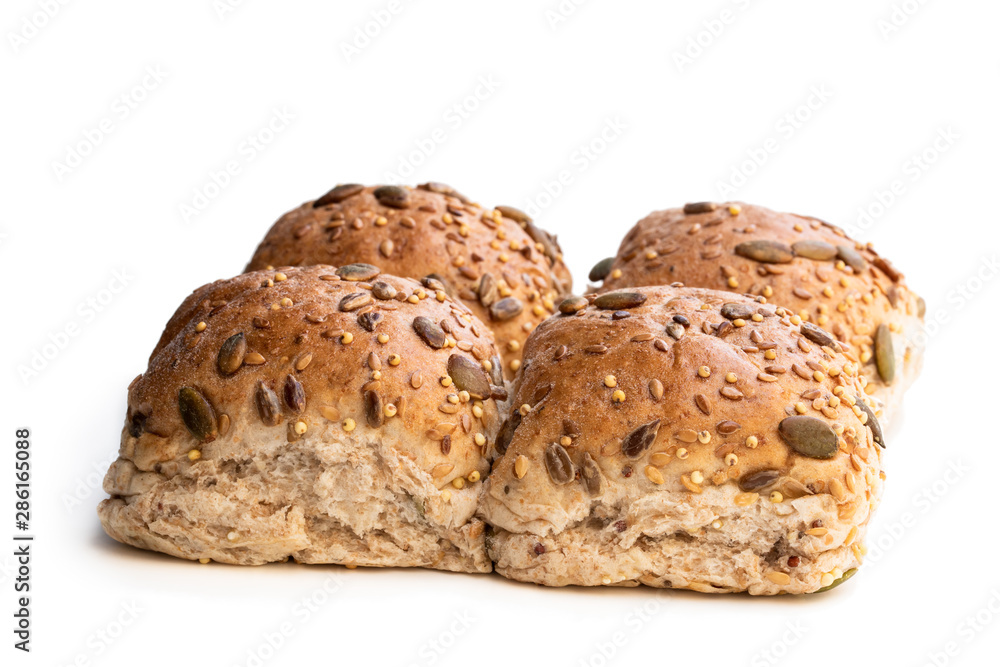 Wholemeal multiseeds batch rolls isolated on white batch of four Wholemeal multiseeds batch rolls isolated on white batch of four