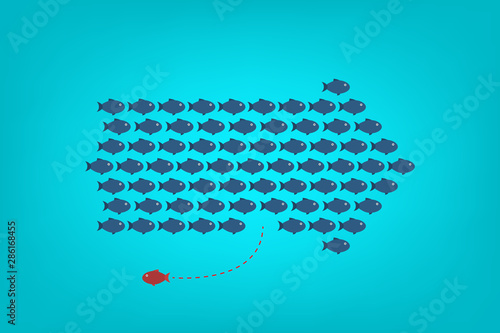 Think differently -One red unique different fish swimming opposite way of identical blue ones.  