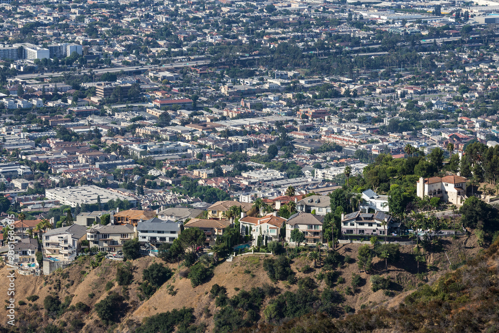 Cityscape view of large hilltop homes above Glendale and Los Angeles in scenic Southern California.
