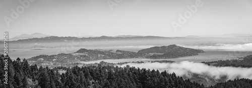 Mountains with fog rolling in over in black and white