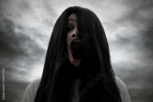 Valokuva Scary bloody ghost woman screaming