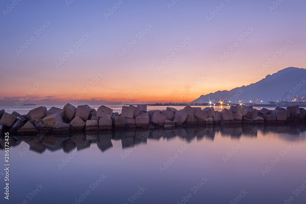 Salerno, romantic sunset over the sea in amaranth colors