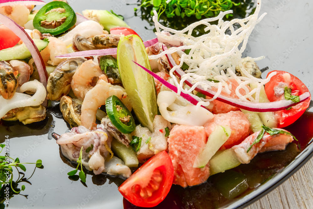 Thai spicy and sour seafood salad on a wooden table