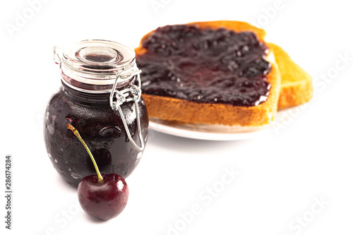 Jar of Homemdae Cherry Jam Isolated on a White Background photo