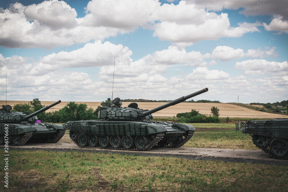 Demonstrative maneuvers of tanks at a military exhibition. Dance of tanks.