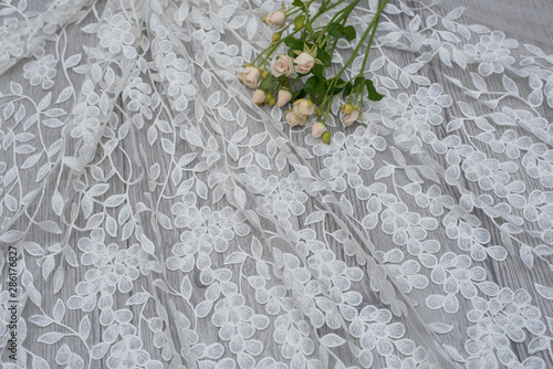 The texture of lace on wooden background decoreted roses. photo