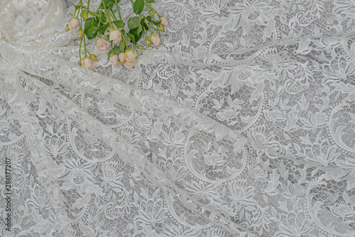 The texture of lace on wooden background decoreted roses. photo