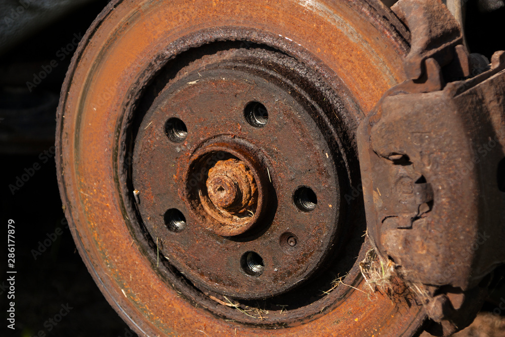 old rusty brake disc on a car close-up old rusty brake disc on a car close-up