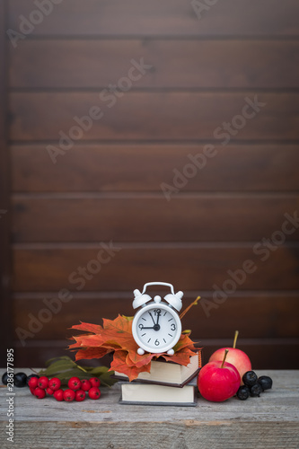 Back to school Alarm clock, maple leaves, apples, ashberries, September 1 concept photo