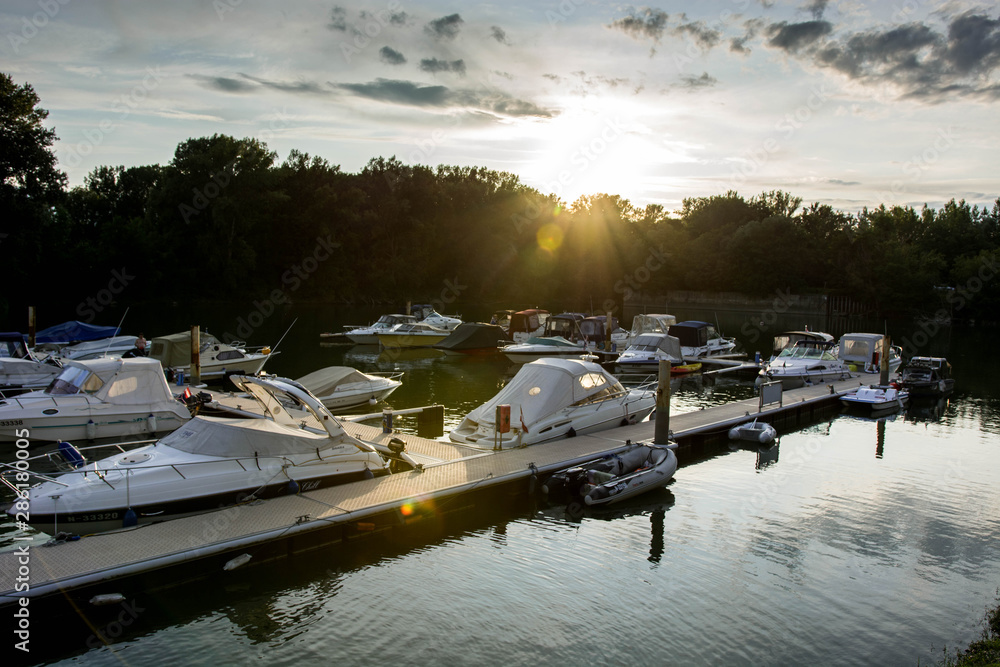 Yachts, speedboats and Boats in a marina during sunset