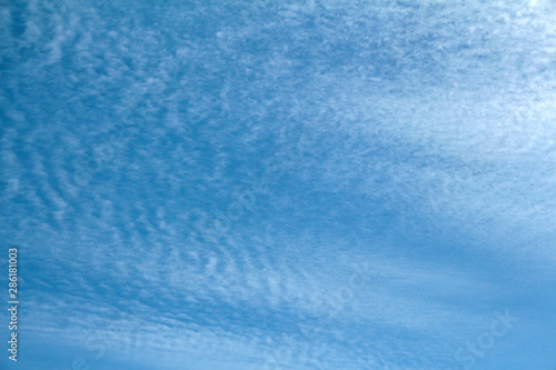 Beautiful cirrus clouds on the blue sky. Abstract nature background
