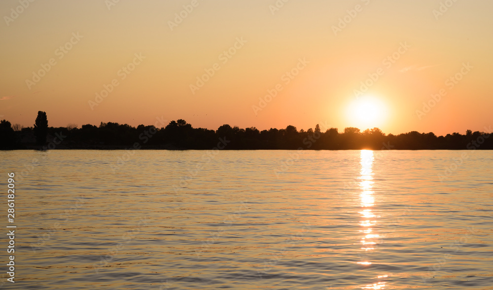 Gorgeous fabulous sunset over the river at night.