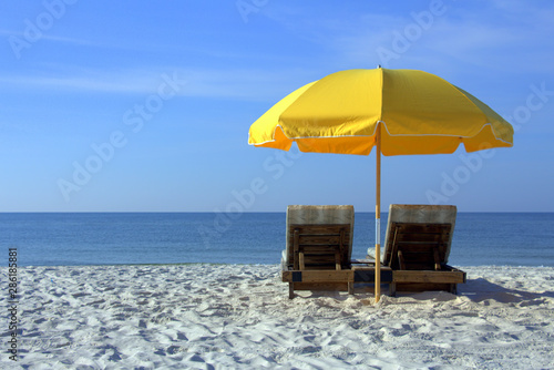 Beach Chairs with Yellow Umbrella on a White Sandy Beach