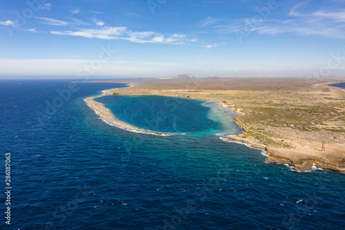 Aerial view of coast of Curaçao in the Caribbean Sea with turquoise water, cliff, beach and beautiful coral reef around Eastpoint