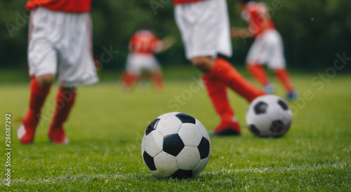 Horizontal Football Background Close-up. Football/Soccer Running with the Ball. Soccer Player Training on the Field. Close-up View of Soccer Ball and Player Leg
