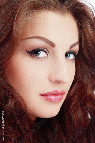 Vintage style portrait of beautiful blue-eyed girl with fancy winged eye makeup