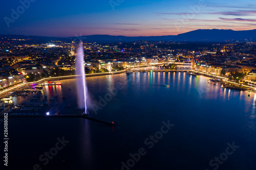 Aerial night view of Geneva city water fountain in Switzerland