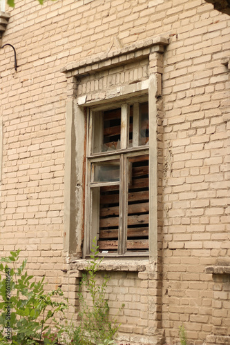 smashed a shot of an old brick building planked window at the Donbass in Ukraine