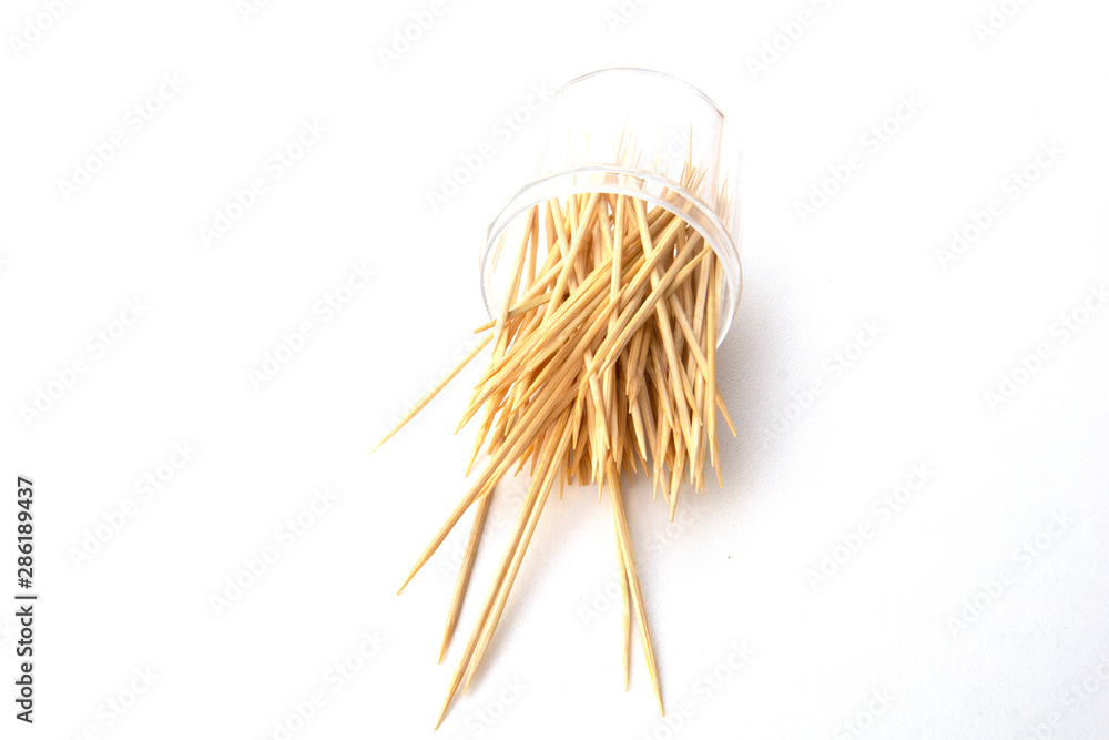 Fototapeta premium Toothpicks isolated on white background. Tooth picks spilling out of container.