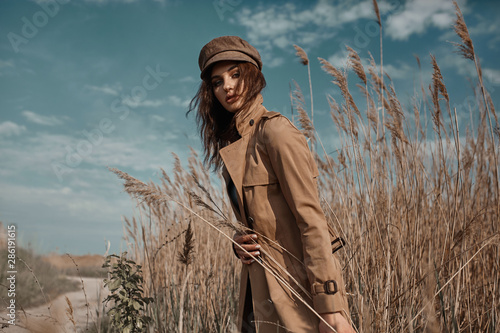 Photography Beautiful Young Stylish Girl in Trench Coat Walking Autumn or Spring street