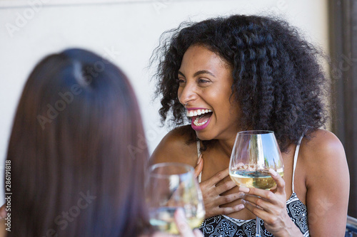 Canvas Print young woman laughing and drinking wine