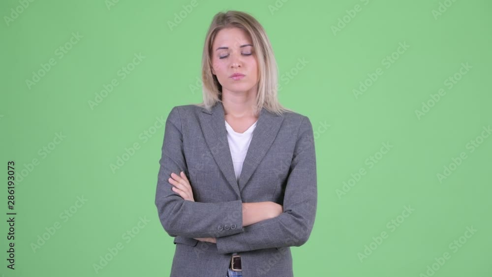 Stressed young blonde businesswoman looking angry with arms crossed Stressed young blonde businesswoman looking angry with arms crossed