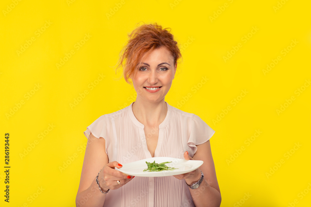 Happy woman with plate of green salad