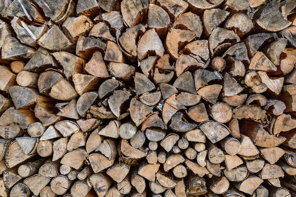 Stack of sawn tree logs. Stacked pile of firewood logs. Lumber industry. Wooden background Stack of sawn tree logs. Stacked pile of firewood logs. Lumber industry. Wooden background