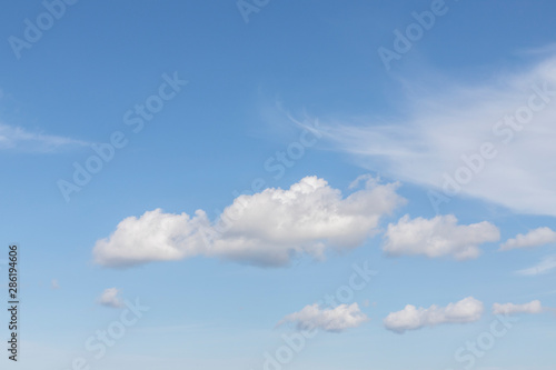 Blue sky with white clouds. In the sky you can see fluffy clouds and feather clouds. Background with free space and empty place.