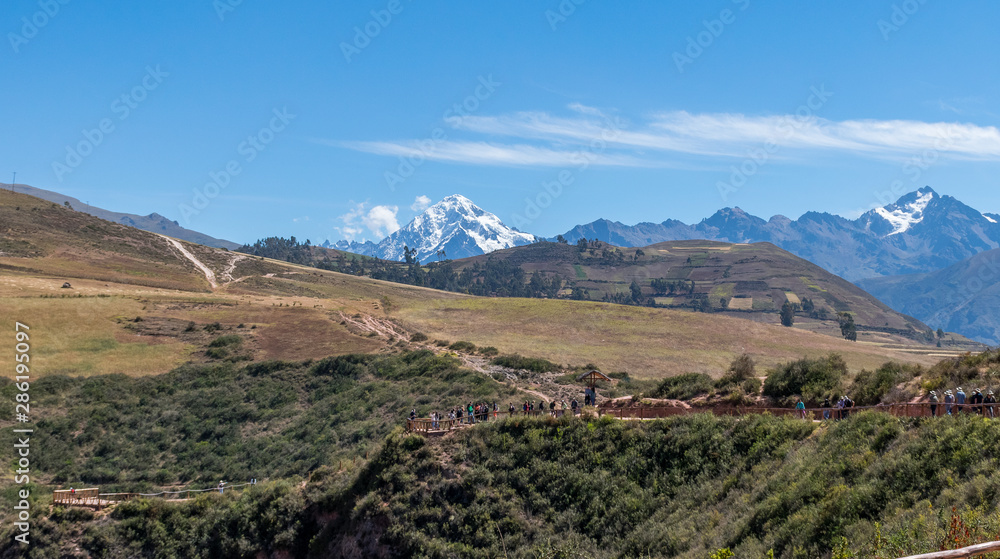 Fototapeta premium Sacred Valley, Peru - 05/21/2019: The inescapable snow peaked Andes mountains in the Sacred Valley of Peru.