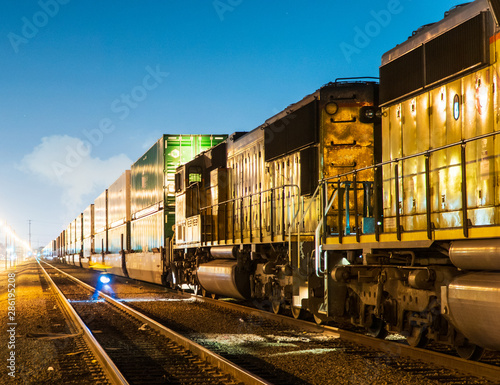 Night Freight Train With Cargo Containers, Transport, Shipping, Import, Export On The Sky Background.