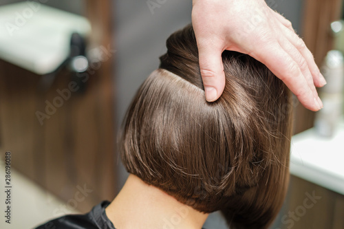 Professional hairdresser makes hairstyle