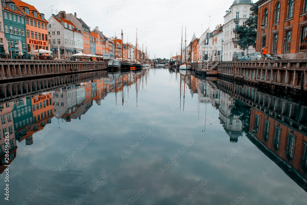 Copenhagen, Denmark - 17 August, 2019: Nyhavn pier with color buildings, ships, yachts and other boats in the old part of town of Copenhagen, Denmark