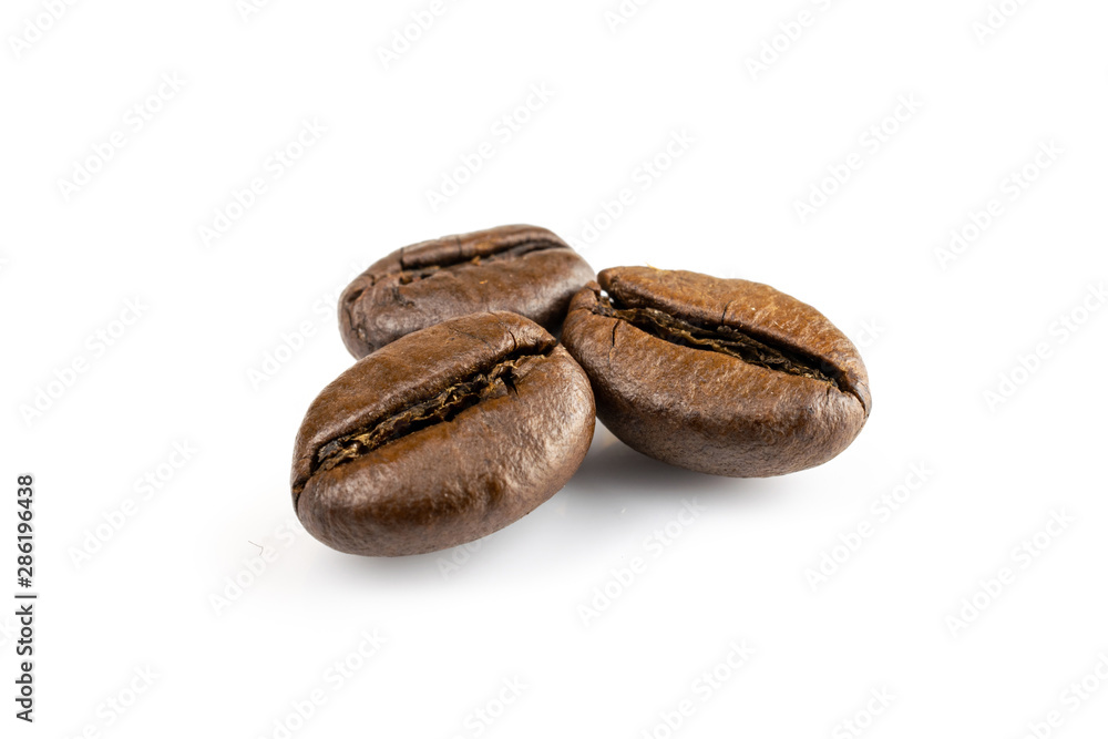 Three shiny fresh roasted coffee beans isolated on white background. Coffee background or texture concept. Three shiny fresh roasted coffee beans isolated on white background. Coffee background or texture concept.
