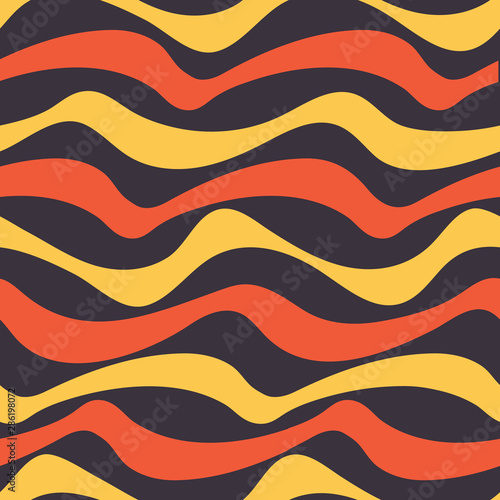 Graphic wavy 70's seamless pattern in yellow, orange and black. Groovy waves in horizontal stripes have a surf vibe. Great for beachwear, posters, graphic design projects and textiles. Vector.