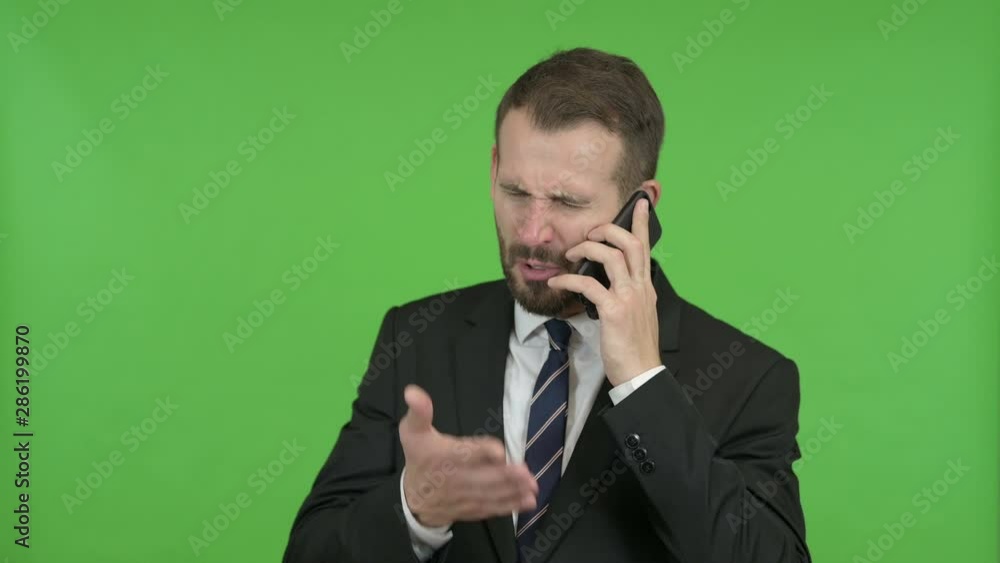 Frustrated Young Businessman get angry on Call against Chroma Key Frustrated Young Businessman get angry on Call against Chroma Key